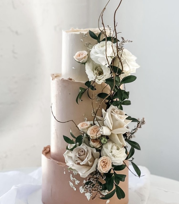 wedding cake with a beautiful wedding flower arrangement