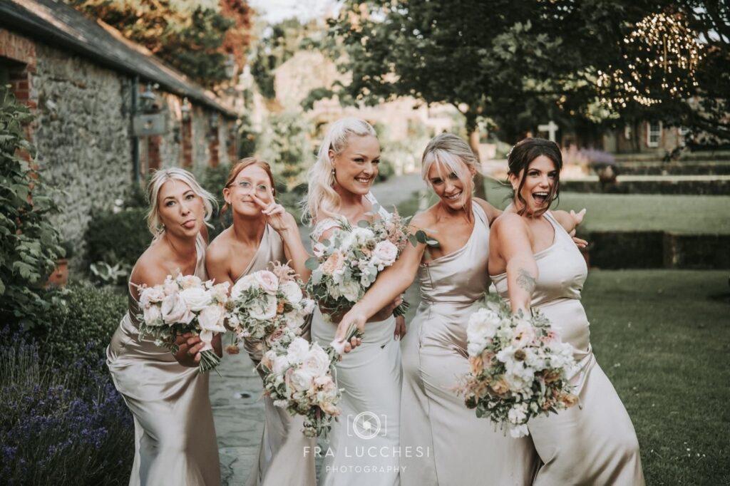 a bride and her bridesmaids with bouquets from willow and sage wedding florist
