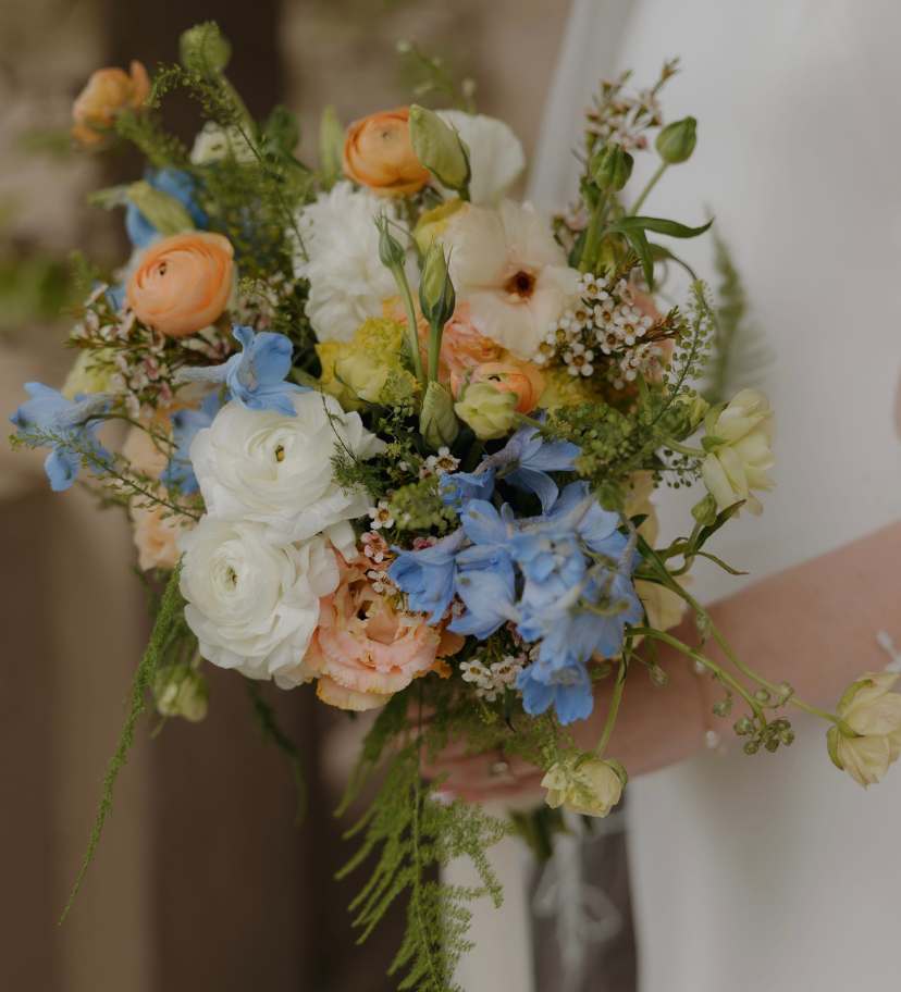 Textured bridal bouquet with seasonal greenery held by a bride in the heart of Northern Ireland.